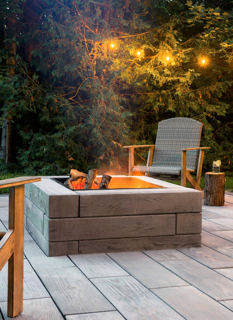 Backyard fire pit designed with our wood look-alike Borealis retaining wall. 