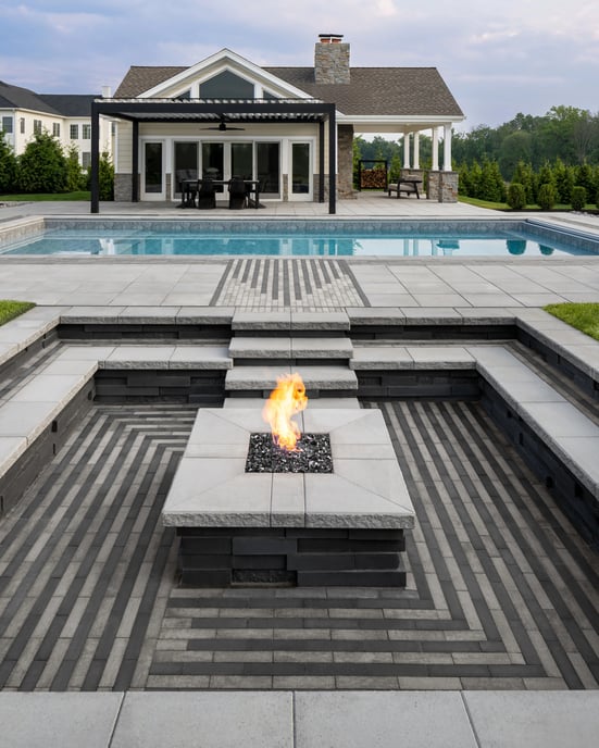 Backyard swimming pool design featuring Techo-Bloc's Industria patio slab and Graphix retaining wall