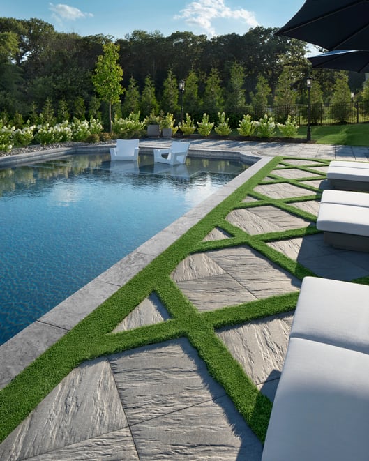 Backyard swimming pool design featuring Techo-Bloc's Everest patio slab 