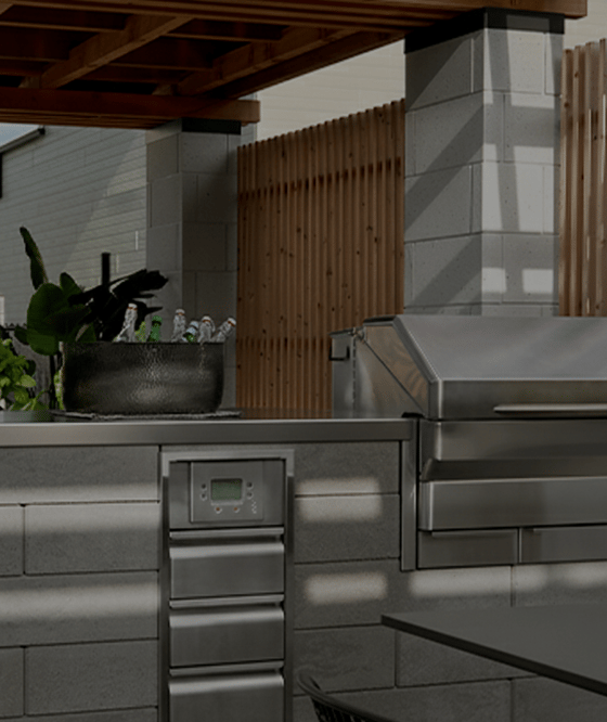 Outdoor kitchen with Techo-Bloc's Raffinato retaining wall and a stainless steel countertop