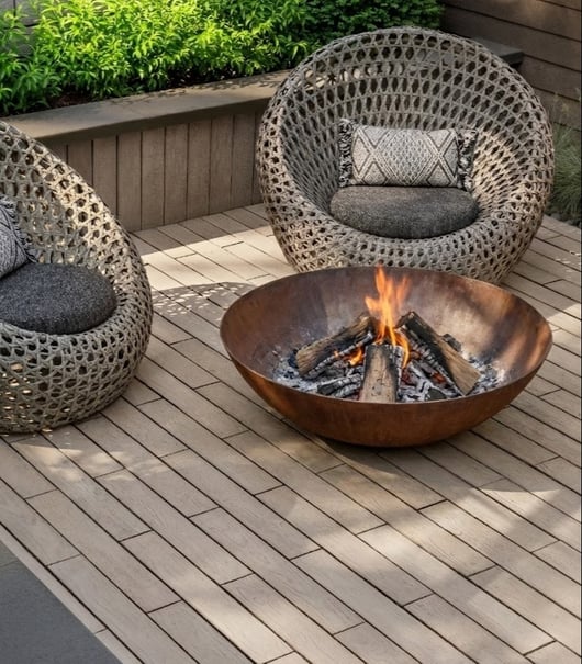 Steel fire bowl sitting on Techo-Bloc's Borealis patio slabs