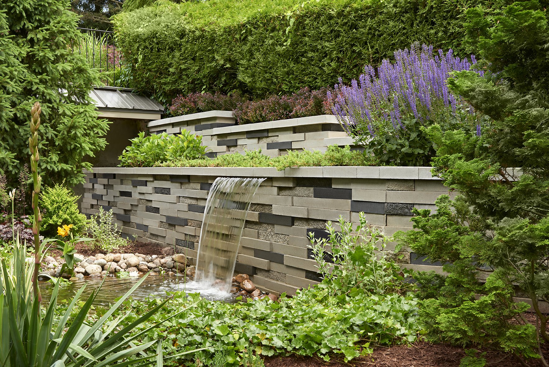 Garden waterfall built with our Graphix retaining wall. 