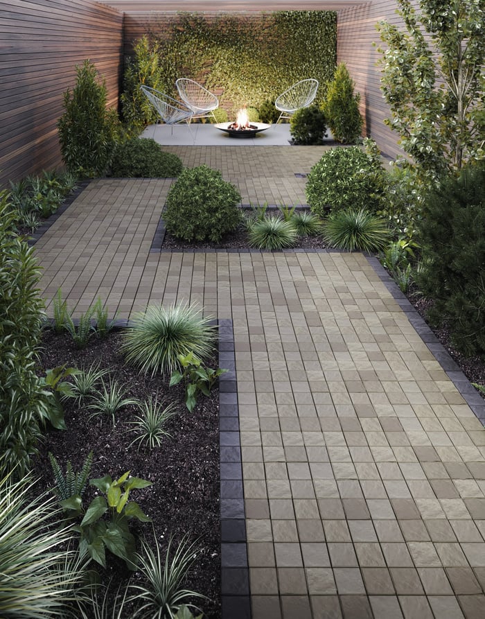 Walkway made of Squadra pavers leading to a small fire pit seating area
