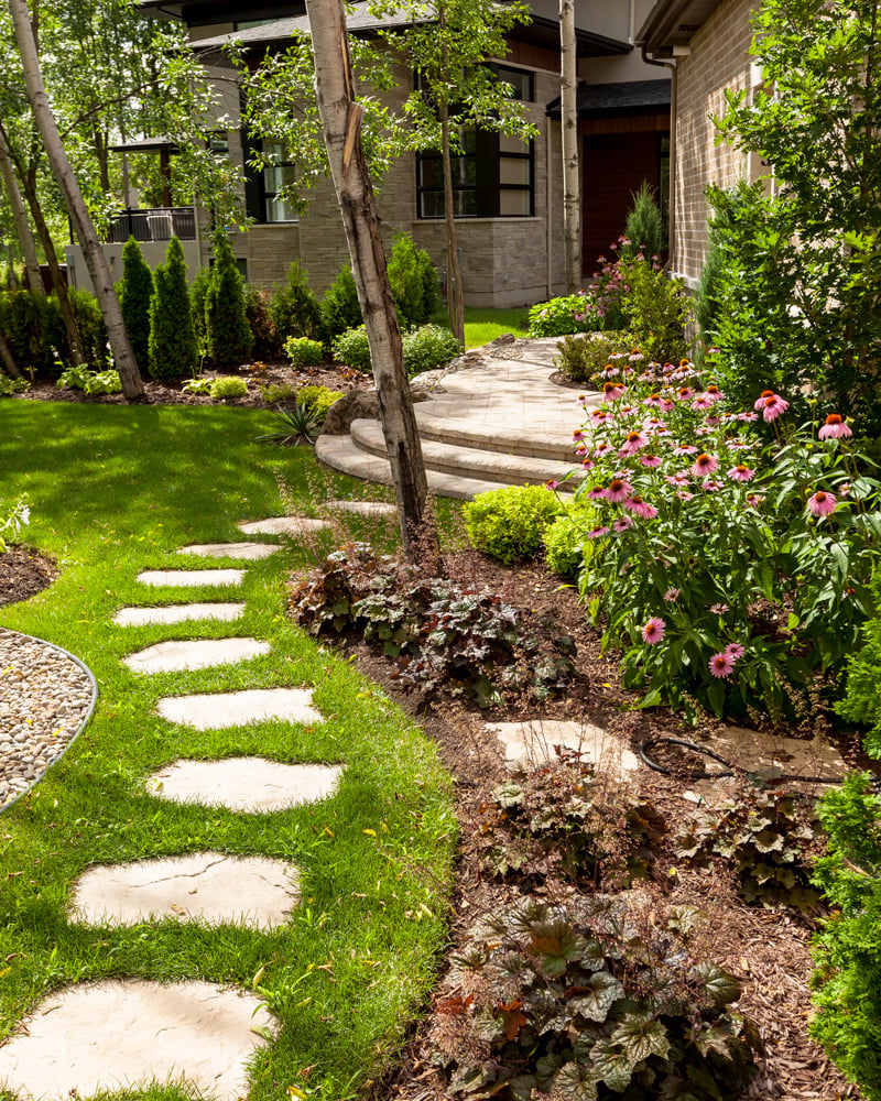 Backyard garden path leading to the patio designed with our Maya concrete stones. 