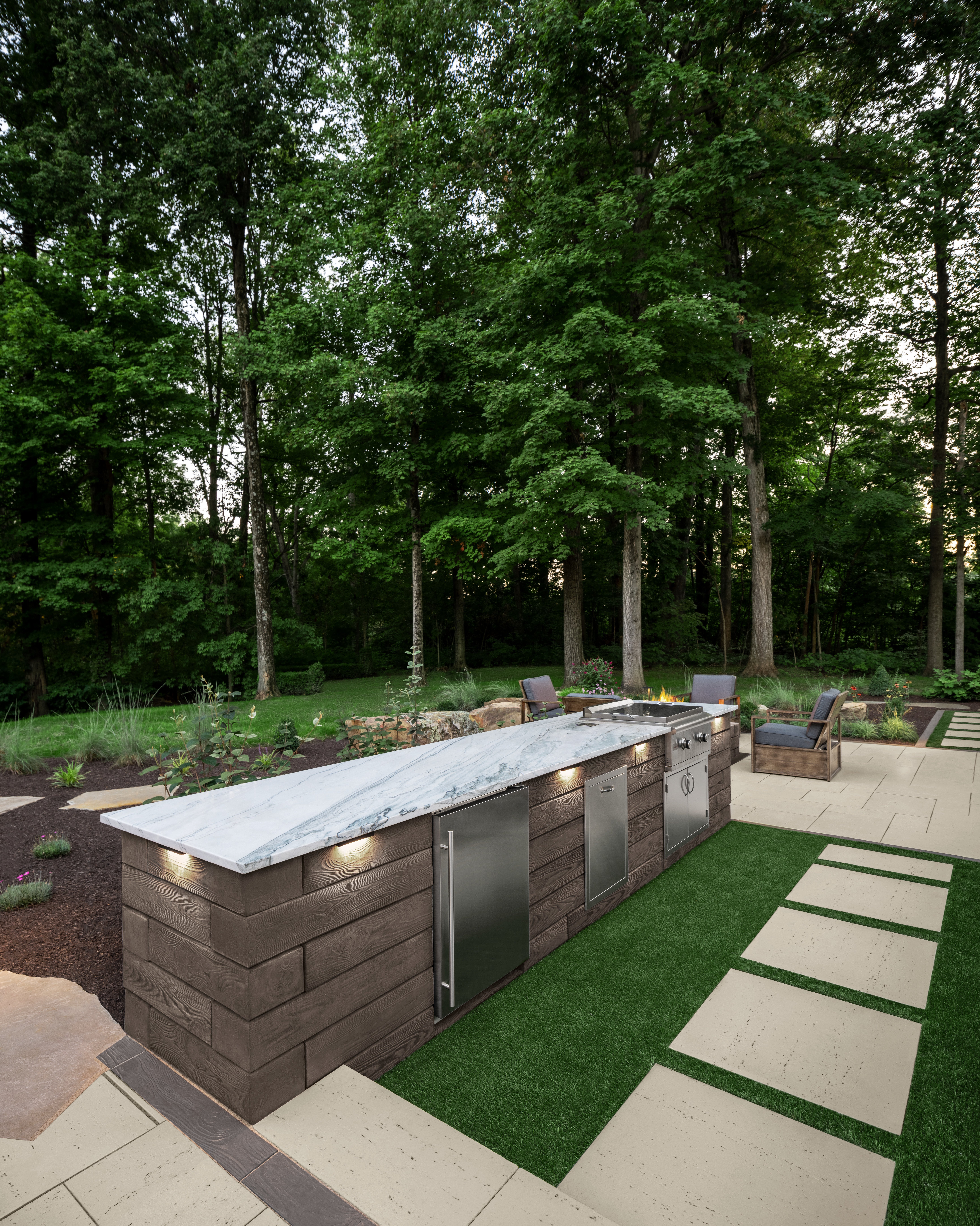 Backyard outdoor kitchen featuring Techo-Bloc pavers and patio slabs